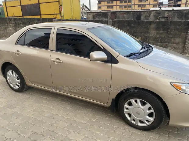 2010 Toyota Corolla LE Sedan - Gold - 1